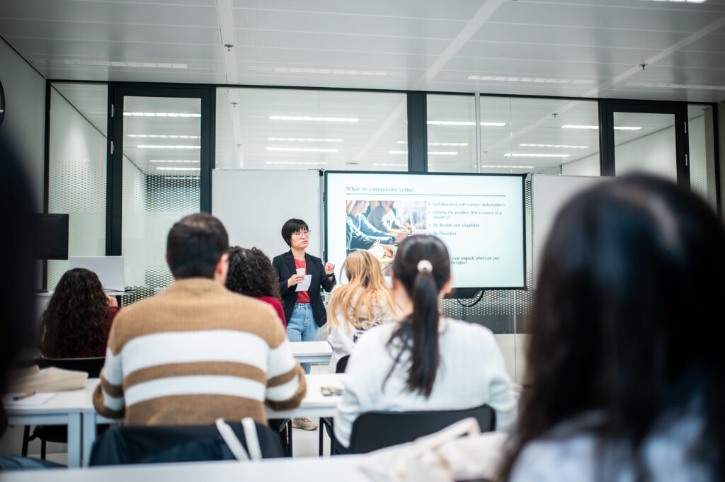 Qing giving a presentation at PhD day in 2025